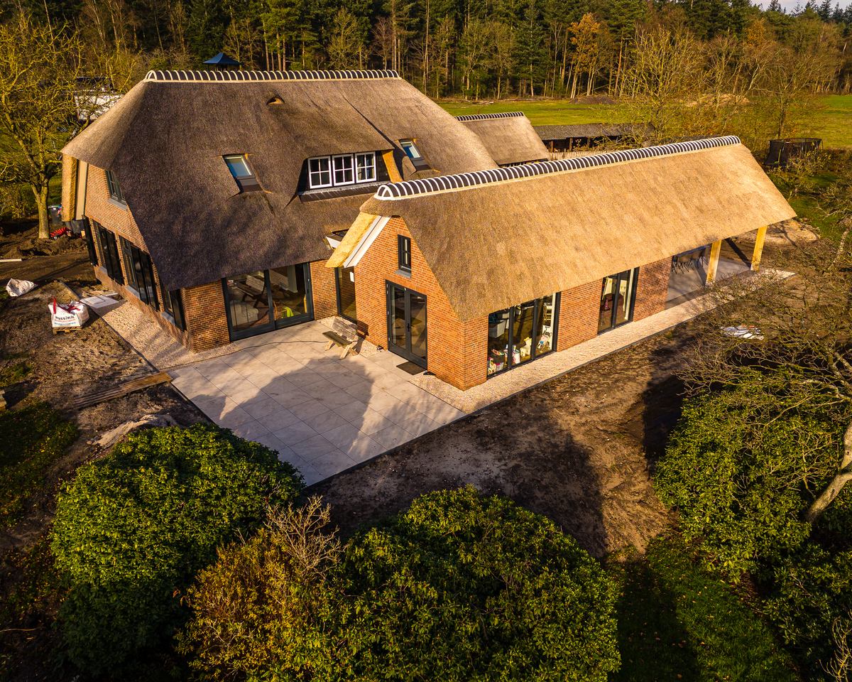 Woning met rieten kap en een nieuw terras, gezien van boven